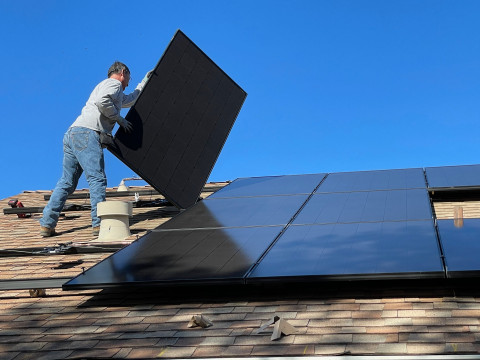 Solar panels being installed on the roof top of a house in Rockwall Texas.